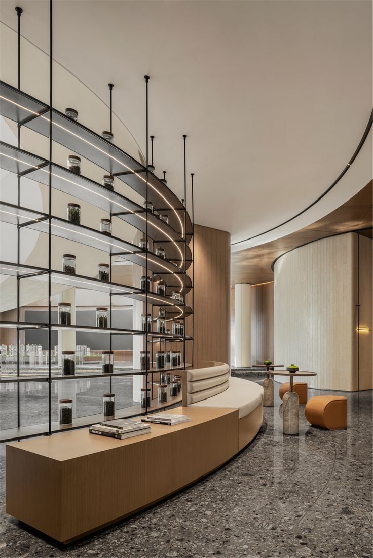 the interior of an apple store with marble flooring and curved glass walls on one side