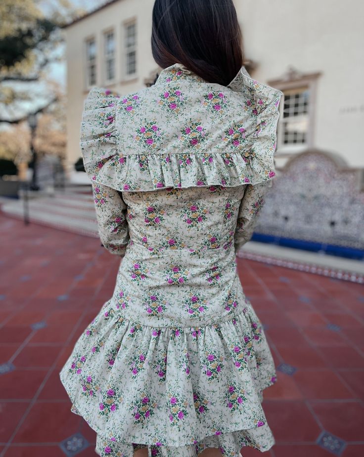 Saddle up in style with the Quinlynn Taupe Floral Ruffle Bow Dress. This versatile dress is perfect for any occasion, whether you're hitting the rodeo in your cowgirl boots or stepping out in the spring sun with wedges. With its playful ruffle and bow details, you'll be the talk of the town. Giddy up and grab yours today! Product Details: Features: Adjustable bow tie. Ruffle details. Side zipper closure. Fit: True to size. Model is 5'3 and wearing a size small. Fabric: 100% cotton; Lining- 100% Fitted Dresses With Ruffle Hem For Day Out, Spring Cotton Dress With Ruffled Skirt, Fitted Flirty Mini Dress For Spring, Spring Daywear Ruffle Dress, Spring Daywear Dress With Ruffle Hem, Spring Knee-length Ruffle Dress, Spring Fit And Flare Dress With Ruffle Hem, Knee-length Ruffle Dress For Spring Garden Party, Knee-length Ruffle Dress For Spring