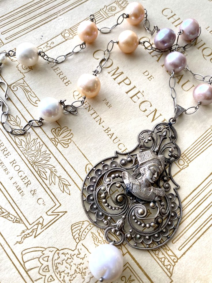 Vintage French Silver Filigree Necklace with Breton Girl and Large Freshwater Pearls Vintage Silver Jewelry With Pearl Charm, Baroque Silver Necklace With Pearl Pendant, Silver Baroque Necklace With Pearl Pendant, Silver Pearl Necklace With Intricate Design, Elegant Silver Pearl Necklace With Intricate Design, Victorian Pearl Necklace With Pearl Pendant, Ornate Silver Baroque Necklaces, Baroque Silver Pearl Jewelry, Baroque Pearl Silver Jewelry