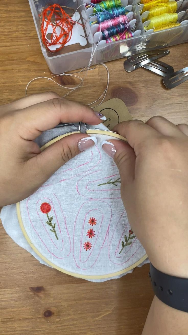 someone is working on an embroidery project