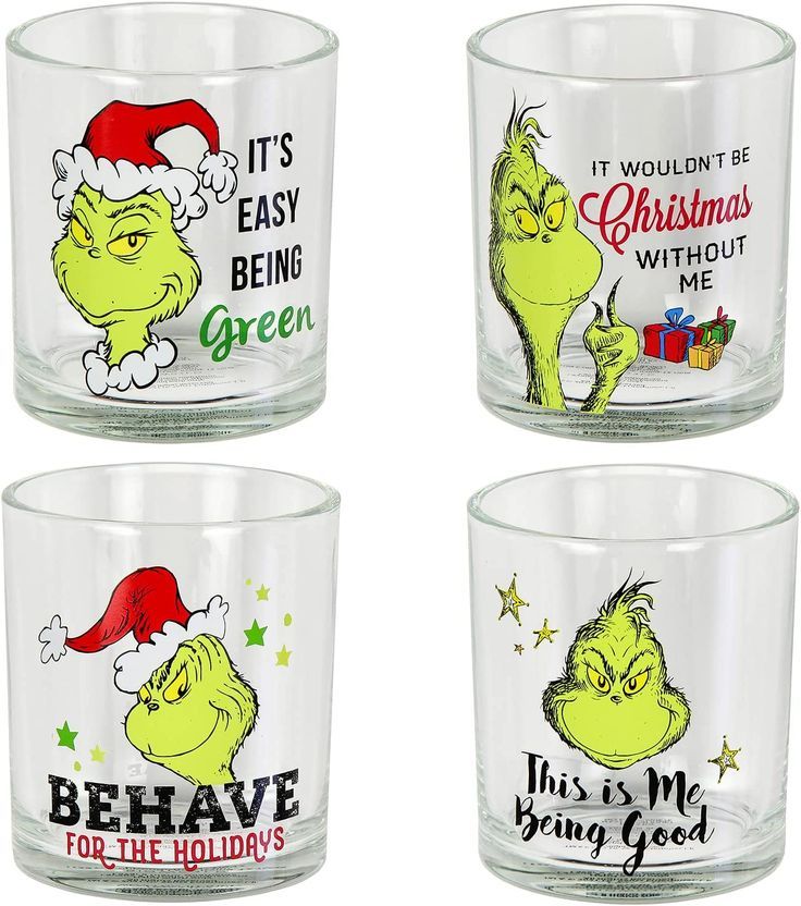 four glass cups with grin face designs on the front and bottom, one has an elf hat