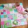 a baby laying on top of a colorful blanket