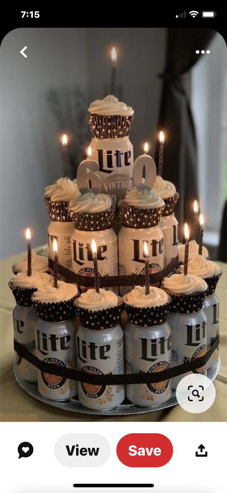 a birthday cake made out of beer cans with lit candles on top and chocolate cupcakes in the middle