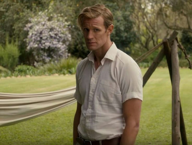 a man standing in front of a hammock