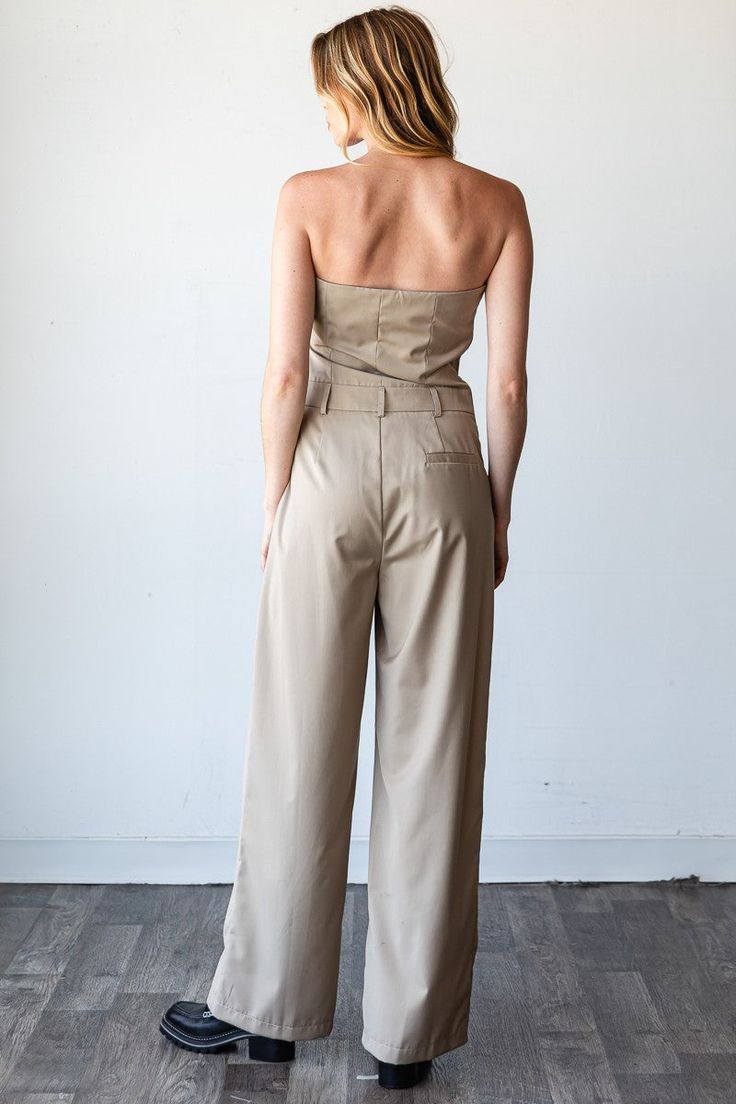 Taupe Pinnacle Bandeau Jumpsuit Step into sophistication with the Taupe Pinnacle Bandeau Jumpsuit, an elegant piece that combines modern style with timeless grace. Ideal for work, formal events, or a chic evening out, this jumpsuit features a flattering bandeau top and wide-leg design that offers both comfort and class. Strapless Bandeau Top: Showcases a sleek and streamlined look with a flattering tube top. Full-Length: Provides an elongated silhouette with wide legs, ideal for a sophisticated Bandeau Jumpsuit, Work Formal, Jumpsuit Blue, Strapless Bandeau, Leg Design, Wide Legs, Bandeau Top, Adjustable Belt, Tube Top