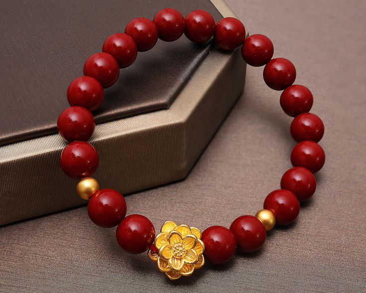 Visist our shop to get more Jewelry ideas and choices! https://www.etsy.com/shop/FamilyJewelryCo Design Name: Strengthful Lotus Design Meaning: The gold lotus and 2 balls rebirth in the surrounded red cinnabar beads means ennergy and strength, purity and rebirth, good luck. Material Lotus & Balls: 24K 999 Gold Red Beads: Red Cinnabar Rope: Elastic Nylon Rope Default Size:  Gold Lotus: 13*13*8.5 MM; Gold Balls: 4 MM (Diameter), about 1-1.1 g Red Beads: 8.5 MM (Diameter) (The Gold Size is fixed, t Gemstone Beaded Bracelets For Festivals And Gifts, Traditional Gold Beaded Bracelets With Gemstone Beads, Traditional Red Bracelets With 8mm Beads, Red Round Beaded Bracelets For Festivals, Traditional Red Gemstone Beads Bracelet, Handmade Jewelry With Round Beads For Gifts, Red Beads For Festivals Gift, Traditional Yellow Gold Beaded Bracelets As Gift, Red Beads For Festival Gifts