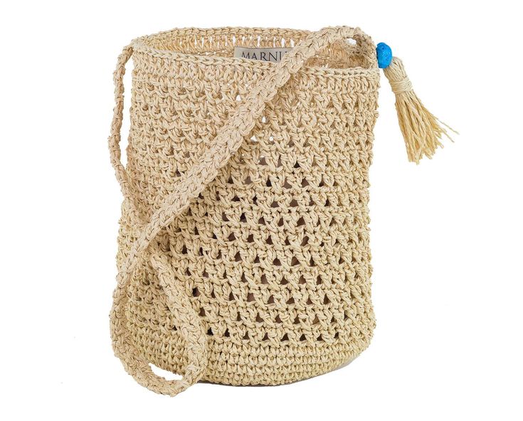 a crocheted bag with a tasseled handle