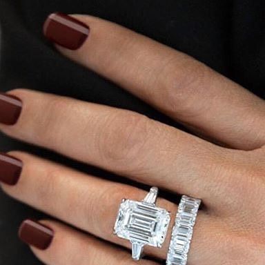 a woman's hand with two rings on her fingers and one ring in the shape of a baguette