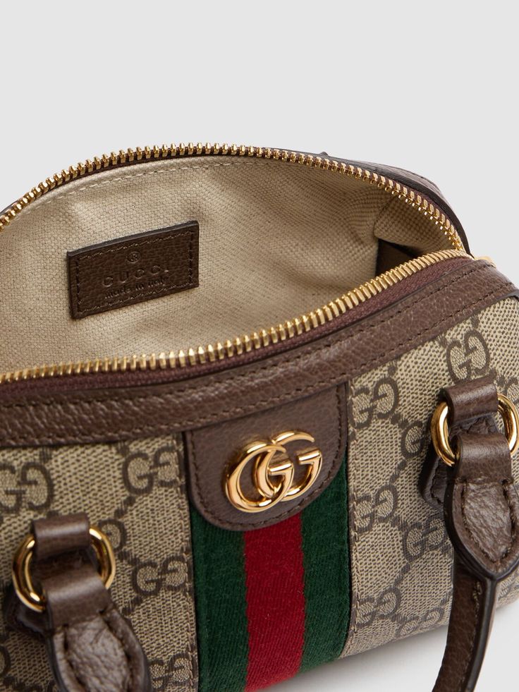 Find GUCCI Ophidia Canvas Shoulder Bag on Editorialist. This GUCCI shoulder bag is crafted from beige and ebony GG Supreme canvas with brown leather trim and gold-toned hardware. The bag features a green and red Web, a double G, and a zip closure. It has a detachable adjustable strap and double top handles. The bag measures 10cm in height, 16.5cm in width, and 9cm in depth. The strap drop is 54cm and the handle drop is 4.5cm. It features an internal keychain hook and a cotton linen lining. The b Gucci Bag With Gold-tone Hardware And Top Handle, Gucci Top Handle Bag With Gold-tone Hardware, Gucci Crossbody Satchel With Top Carry Handle, Gucci Crossbody Satchel, Gucci Crossbody Satchel With Gold-tone Hardware, Gucci Brown Satchel Bag, Luxury Monogram Canvas Satchel With Gold-tone Hardware, High-end Brown Shoulder Bag With Gold-tone Hardware, Gucci Brown Coated Canvas Shoulder Bag