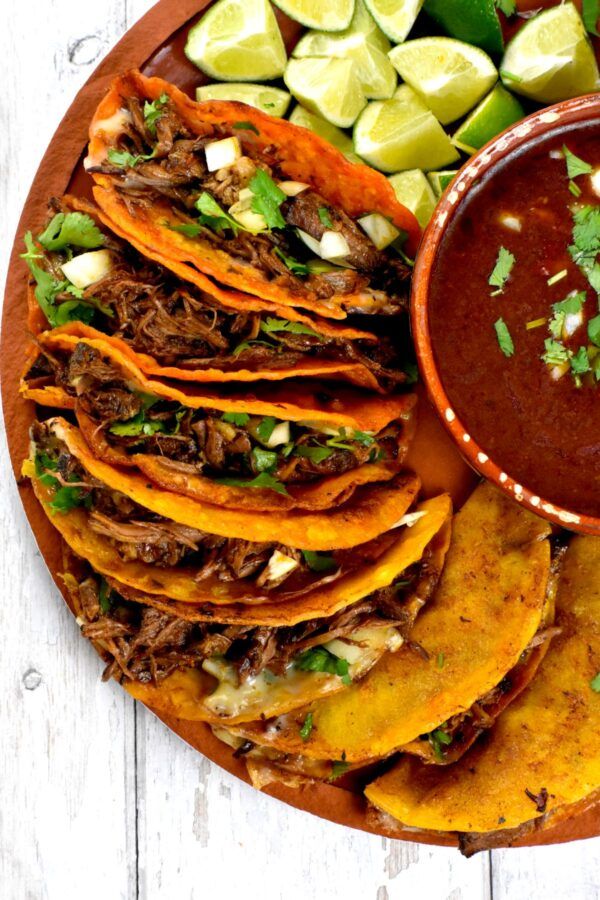 a plate with tortillas, guacamole and salsa