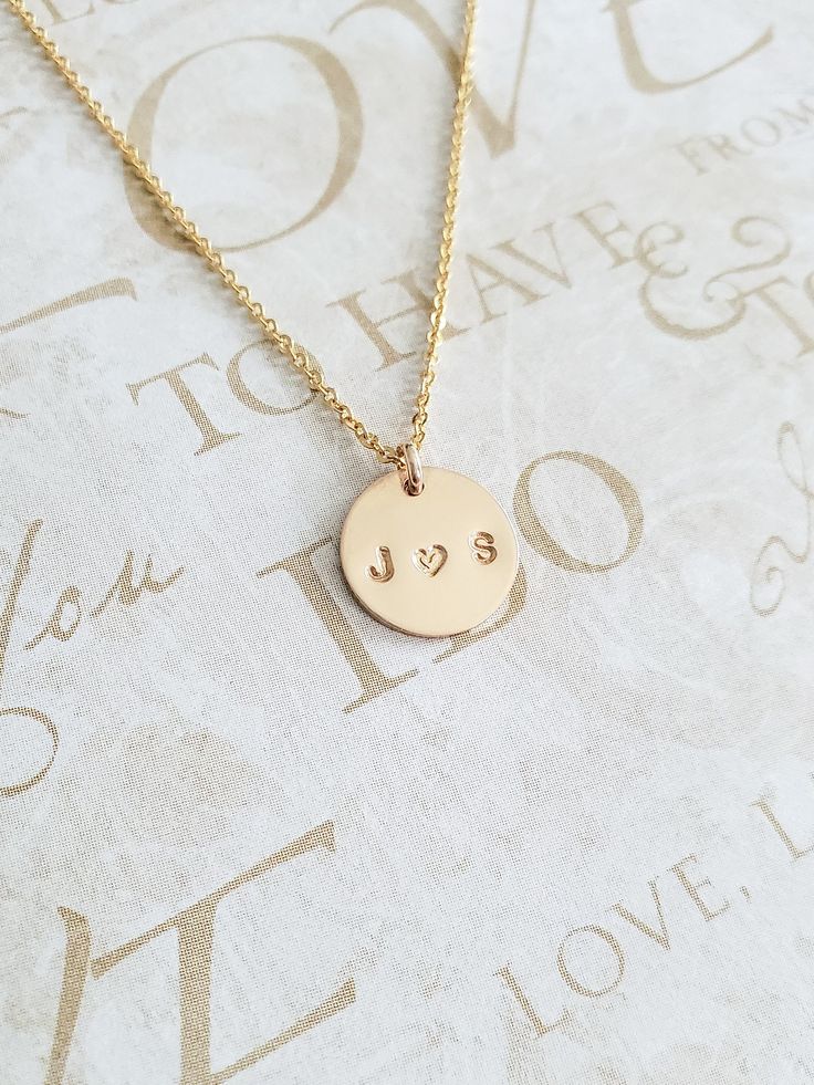 "Couples Initial Necklace - 14K Gold Filled - Mothers Gift - Name Necklace - Initial Necklace - Personalized Necklace - Gift for Her - 11mm * Dimensions: 11mm Diameter 14K Gold Filled Circle Disc Pendant * Necklace Chain Length: Available in 14in, 16in, or 18in ---------------------------------- HOW TO ORDER 1. Select the length that you would like from the drop down menu. * This item only comes in Font Type 3 (1.5mm)* This listing is for (1) necklace. Please feel free to let us know if you have Dainty Hand Stamped Necklaces For Anniversary, Minimalist Hand Stamped Jewelry For Anniversary Gift, Anniversary Jewelry With Round Disc Pendant, 14k Gold Hand-stamped Charm Necklace For Anniversary, 14k Gold Charm Necklace For Anniversary, Stamped 14k Gold Necklace For Anniversary, Gold Hand Stamped Round Pendant Jewelry, Stamped 14k Gold Round Pendant Necklace, Gold Hand Stamped Round Pendant