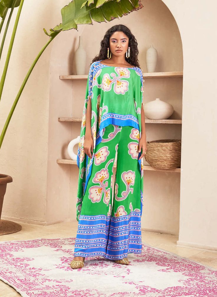 Introducing the co-ord set, where contemporary design meets meticulous detailing. The straight pants are adorned with a carefully placed border, adding a subtle yet stylish touch. The kaftan-style ... Festive Green Bohemian Pant Set, Silk Sets With Printed Motifs In Maxi Length, Green Silk Palazzo Set With Printed Motifs, Silk Maxi Sets With Printed Motifs, Bohemian Green Palazzo Set With Printed Motifs, Green Bohemian Palazzo Set With Floral Print, Green Silk Palazzo Set For Summer, Silk Maxi Sets For Spring, Festive Green Silk Pant Set