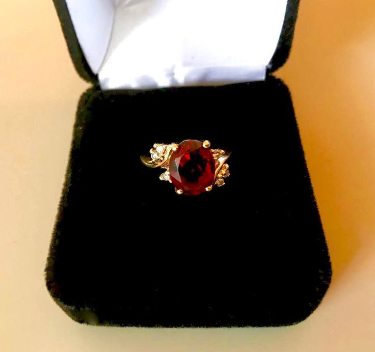 14K YELLOW GOLD, Vintage ring of solid gold, set with an oval facet garnet (3.20ct) accented with six 0.09ctw of fine full cut round brilliant (SI, H-I) diamonds. Item: Garnet and Diamond Ring Gemstones: Garnet (natural, oval facet); Diamonds (natural, full cut round brilliant) Approx. Measurement or Weight of Gem Stones: Garnet: 10.0mm x 8.15mm x 4.9mm (3.20ct); Diamonds: 6 @ 1.5mm (0.09ctw) Color: H-I Clarity: SI Mounting metal: 14K Yellow Gold Approx. Size or length: Size 5.5, band is 1.9mm w Round Cut Gemstones With Diamond Accents For Gift, Gold Diamond Gemstones With Accent Stones, 14k Gold Ruby Ring With Brilliant Cut Oval Shape, Oval Brilliant Cut Ruby Ring In 14k Gold, Gold Oval Gemstones With Brilliant Cut, Fine Jewelry Yellow Gold Gemstones With Diamond Accents, Round Gemstones With Diamond Accents For Gifts, Elegant Oval Gemstones With Diamond Accents, Yellow Gold Cubic Zirconia Gemstones With Accent Stones