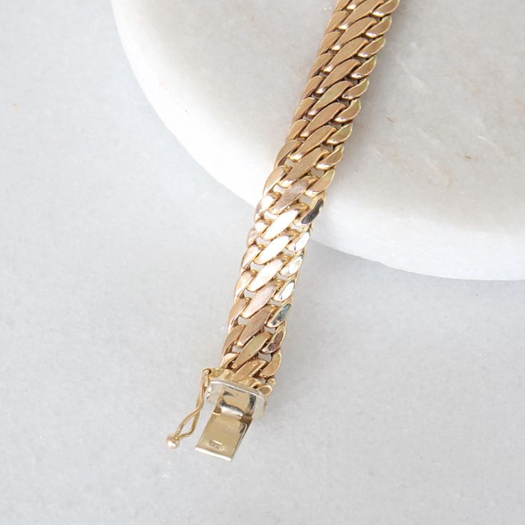 This stunning vintage bracelet crafted in 14k yellow gold and is perfect to wear on its own or layered with other bracelets! Metal: Genuine 14k yellow gold Closure: Box with clip Width: 7.8 mm Length: 7.5 inches Weight: 8.1 grams Please allow up to 5 business days for processing. Currently only shipping within Canada and the USA.  | c u r a t e d | Visit our website for curated and modern pieces  https://www.menkduke.com | f a c e b o o k | Follow us on Facebook for new item announcements and di Antique Gold Bracelets For Anniversary, Antique Gold Bracelet Strap Jewelry, Timeless Gold Bracelet With Curb Chain For Formal Occasions, Formal Gold Cuban Link Bracelet With Polished Finish, Timeless Formal Bracelet With Curb Chain, Timeless Curb Chain Bracelet For Formal Occasions, Timeless Formal Curb Chain Bracelets, Gold Curb Chain Bracelets For Formal Occasions, Gold Classic Diamond Bracelet For Formal Occasions