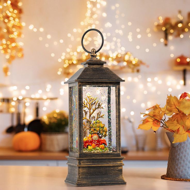 a lantern with flowers in it sitting on a table