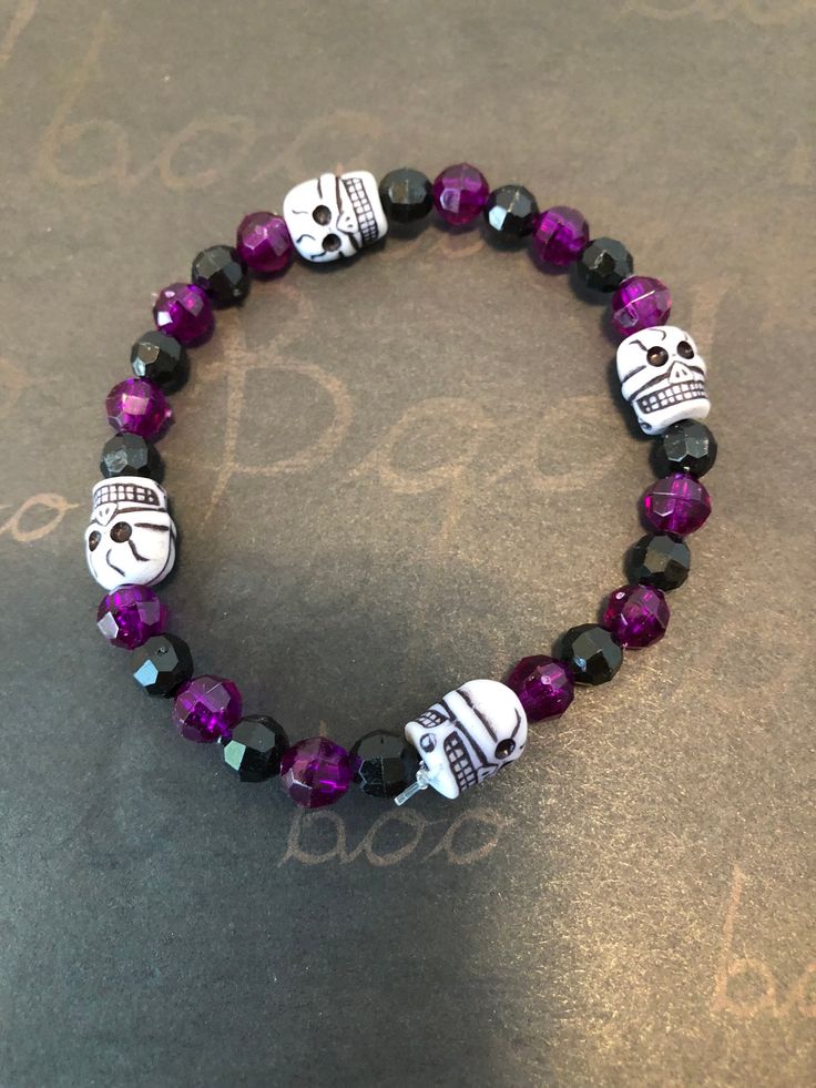 This is a Halloween Skull beaded bracelet. It would make a great addition to your Halloween costume. It would make a great gift for Halloween. It has purple and black 6mm faceted beads. It has four skull beads. It was made with .8mm sturdy stretch string. I tie it several times to prevent breakage. It fits most teens and women. It stretches to fit on the wrist.   All items are ready to be shipped I do combined shipping. Items ship in 2-5 business days. Check out more items at: http://www.etsy.com/shop/MesheleCrafts Halloween Jewelry Diy, Gifts For Halloween, Bloomington Illinois, Skull Beads, Halloween Bracelet, Halloween Beads, Kandi Bracelets, Skull Bracelet, Beaded Skull