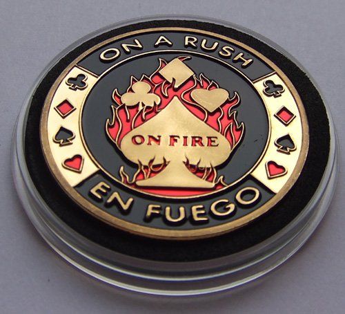 a coin with the words on it that says on fire en fuego in gold and black