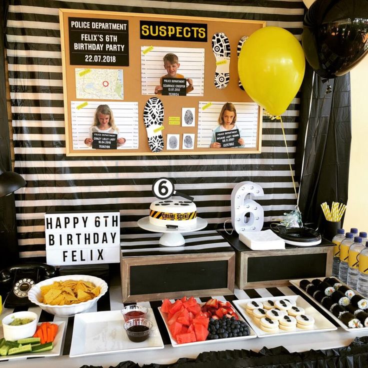 a table topped with lots of food and balloons