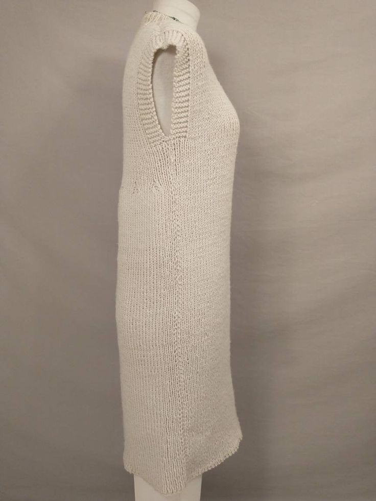 "Beautiful handmade thick sweater dress - jumper - long tunic vest. Very versatile and many different looks attainable. No labels, yarn feels like a super high quality acrylic. Has the Aran wool cream coloration, a natural & neutral color. Great workmanship and stitch work. Very strechy. Measurements flat unstretched. Condition excellent, no stains, damage, wear, or issues. Length 39\" Shoulder 19\" Pit to pit 18\" (36\" stretch to 52\") Waist 39\" Hips 40\" Hem circumference 46' Wt 1.6lb 2 Fitted Sleeveless Knitted Sweater Dress, Fitted Cream Knit Sweater Vest, Casual Sleeveless Knitted Sweater Dress, Fitted Sleeveless Wool Sweater, Fitted Sleeveless Knit Sweater, Cozy Fitted Knitted Sweater Vest, Sleeveless Knit Sweater In Cream, Sleeveless Knit Cream Sweater, Sleeveless Knitted Sweater Dress For Fall