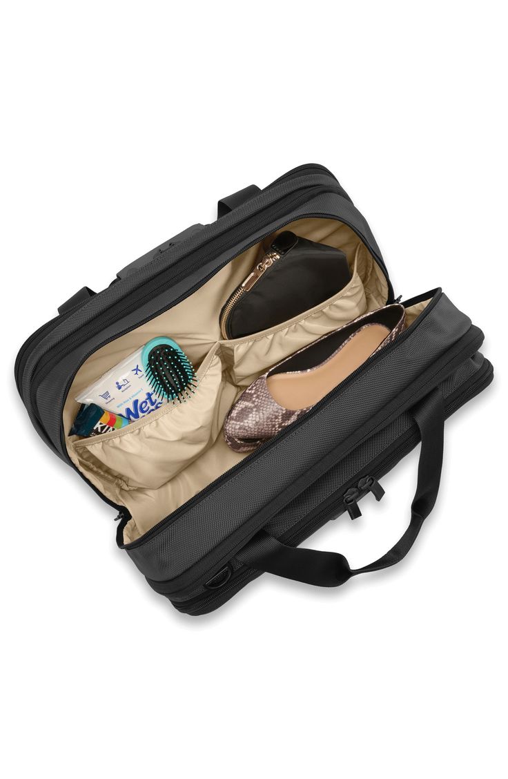 an open suitcase with shoes and other items in it on a white background, side view