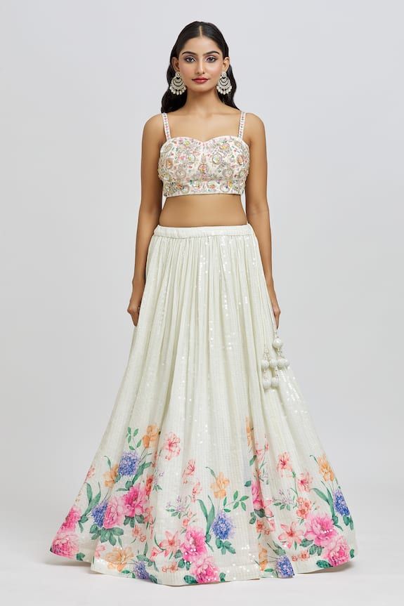 Ivory attached cancan lehenga with floral blossom print, accentuated with all over sequin embroidery. Paired with a padded blouse with all over embroidery using sequin, zari, nakshi and cutdana work and dupatta. - Aza Fashions White Lehenga With Floral Embroidery For Party, White Floral Embroidered Lehenga For Party, Floral Print Lehenga For Spring Wedding, Spring Wedding Lehenga With Floral Print, White Floral Print Party Sets, Fitted Lehenga With Intricate Embroidery For Summer, Summer Lehenga With Intricate Embroidery, White Floral Print Choli For Reception, Fitted Floral Embellished Sets For Reception