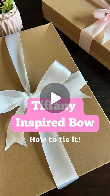 an open gift box with a bow on it and the words, tiffany inspired bow how to tie it