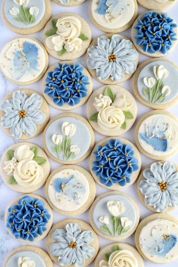 decorated cookies with blue and white flowers on them