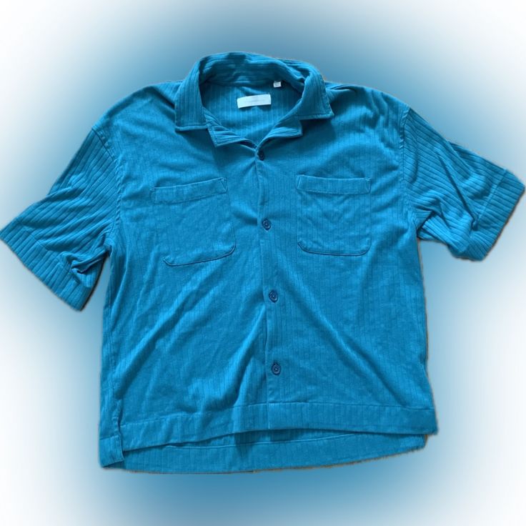 Design: This Soft Cotton Crinkle Shirt By Standard Cloth Is Cut In A Classic Silhouette With A Button-Down Front And Notched Collar, Short Sleeve Style With A Pocket At The Left Chest. This Shirt Is An Urban Outfitters Exclusive. Condition: Never Worn And In Great Condition With No Damages Or Flaws. Summer Cotton Shirt With Crinkle Texture, Blue Relaxed Fit Tops With Buttons, Casual Button-up Top With Crinkle Texture, Casual Crinkle Texture Button-up Tops, Urban Outfitters Collared Tops With Button Closure, Urban Outfitters Collared Top With Button Closure, Casual Crinkle Texture Shirt For Spring, Summer Crinkle Texture Button-up Tops, Urban Outfitters Collared Button-up Top