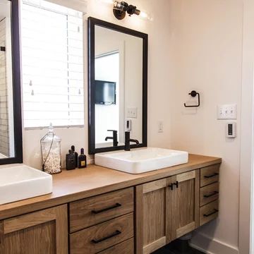 a bathroom with two sinks and large mirrors