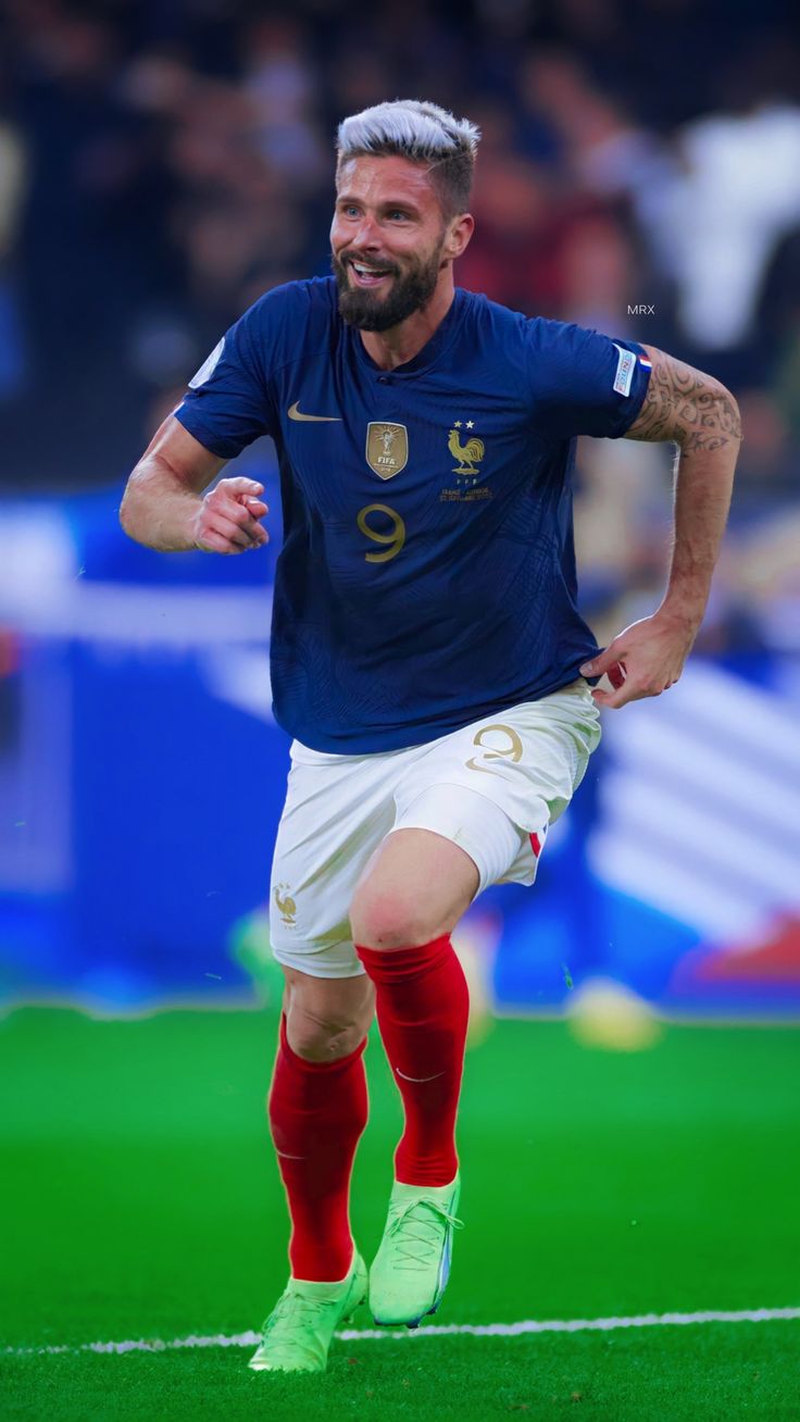 a man with a beard running on a soccer field