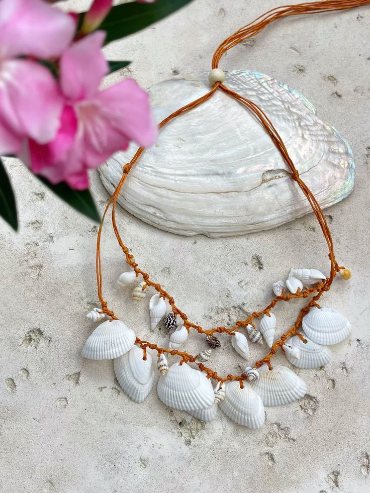 Discover the perfect blend of beachy elegance and boho charm with our Statement Seashell Choker Necklace. Handcrafted from natural white seashells, this unique piece is made for free spirits and beach lovers who want to carry a bit of the ocean with them wherever they go. 🌊 Whether you're dressing for a beach vacation, a seaside wedding, or simply adding a coastal touch to your everyday style, this natural seashell choker is designed to complement any look. Its minimalist, boho style makes it a Seashell Choker, White Seashells, Seaside Wedding, Seashell Necklace, Handcrafted Art, Boho Designs, Eco Friendly Fashion, Beach Lovers, Everyday Style