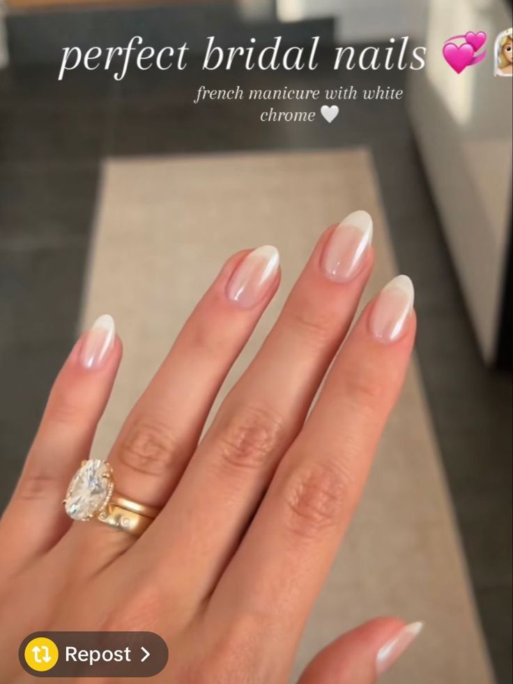 a woman's hand with french manies and a diamond ring on her finger