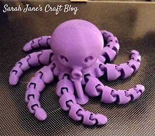 a purple octopus toy sitting on top of a table