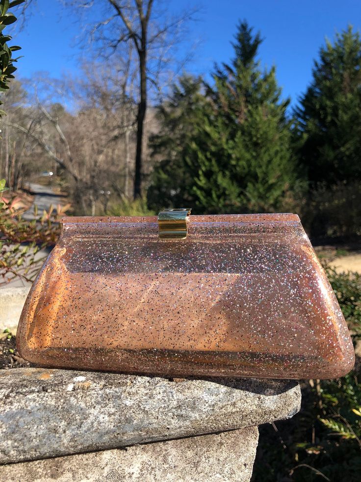 "Thank You If You Favored One of My Items! You Will Receive 10% Off an Item of Your Choice, Unless It Is On Sale, Code17. Thank You. PINK SPARKLE Lucite Clutch/Lucite Handbags/Lucite Clutches/Lucite Purses/50's Clutches/50's Handbags/Vintage Clutches/Near MINT Condition Circa 50's PINK SPARKLE Lucite Clutch This is a Lovely Pink Sparkle Clutch. The sparkles are Fushia, Turquoise, and Silver. The hardware is gold tone. Inside it has two sections and a center compartment that are a rose beige in c Vintage Rectangular Party Bag, Vintage Brown Evening Bag For Party, Vintage Brown Party Bag, Vintage Brown Party Bags, Mid-century Rectangular Party Bags, Classic Brown Party Bag, Vintage Satchel Evening Bag For Parties, Vintage Pink Evening Bags, Retro Brown Bags For Party