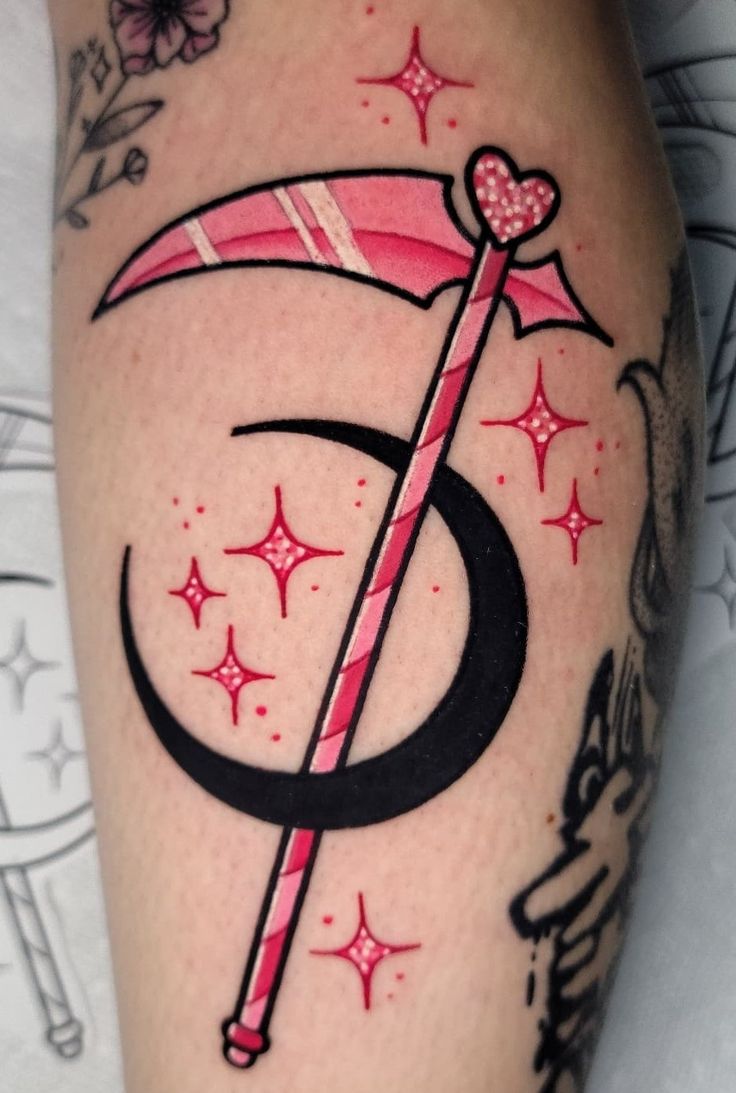 a woman's leg with a pink umbrella tattoo on her left arm and the letter c in black ink