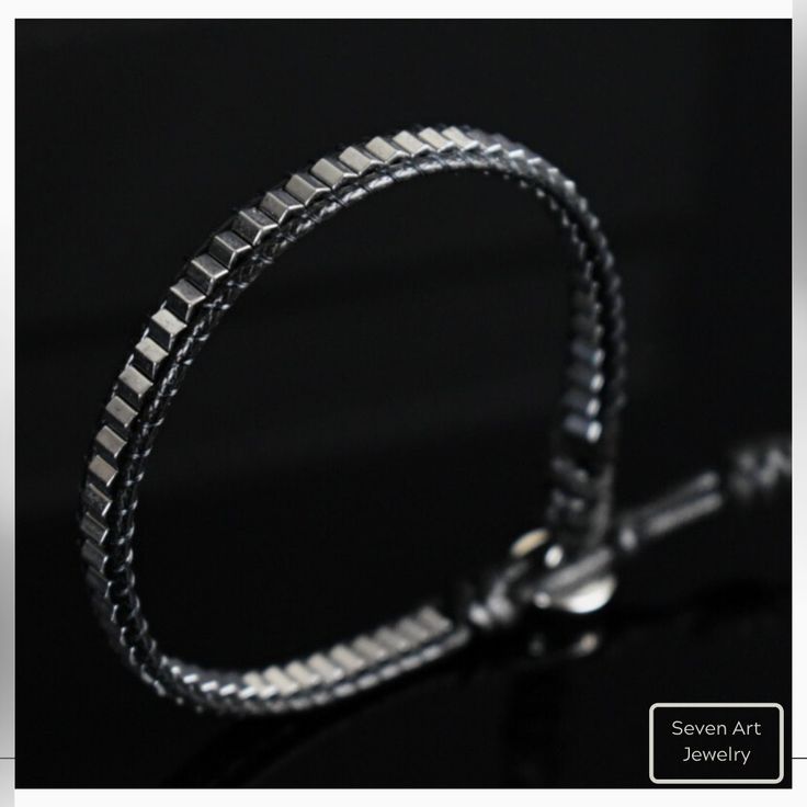 This special design natural gemstone bracelet made with 4*3 mm hexagon shaped Hematite. It is a perfect gift for you and all your loved one for all special days.  All our designs prepared by hand according to the your given sizes with love. Wrap is durable 1,5 mm polyester black rope. For closure of our high quality bracelet we used zamak alloys button with 2 optional closure buttonhole. Used Materials; 4*3 hexagon silver hematite 1.5 mm black korean rope 1 cm zamak alloys button ☆ABOUT US☆ https://www.etsy.com/shop/SevenArtJewelry?ref=listing-shop2-all-items-count#about ☆OUR POLICIES☆ https://www.etsy.com/shop/sevenartjewelry#policies Thanks for your visit Seven Art Jewelry Modern Silver Beaded Bracelet As Gift, Minimalist Sterling Silver Adjustable Box Chain Bracelet, Minimalist Adjustable Sterling Silver Bracelet With Box Chain, Minimalist Sterling Silver Box Chain Bracelet Gift, Modern Chain Bracelet As Gift, Nickel-free Modern Beaded Bracelets As Gift, Modern Nickel-free Beaded Bracelets For Gifts, Adjustable Box Chain Bracelet As Gift, Adjustable Box Chain Bracelet For Gift