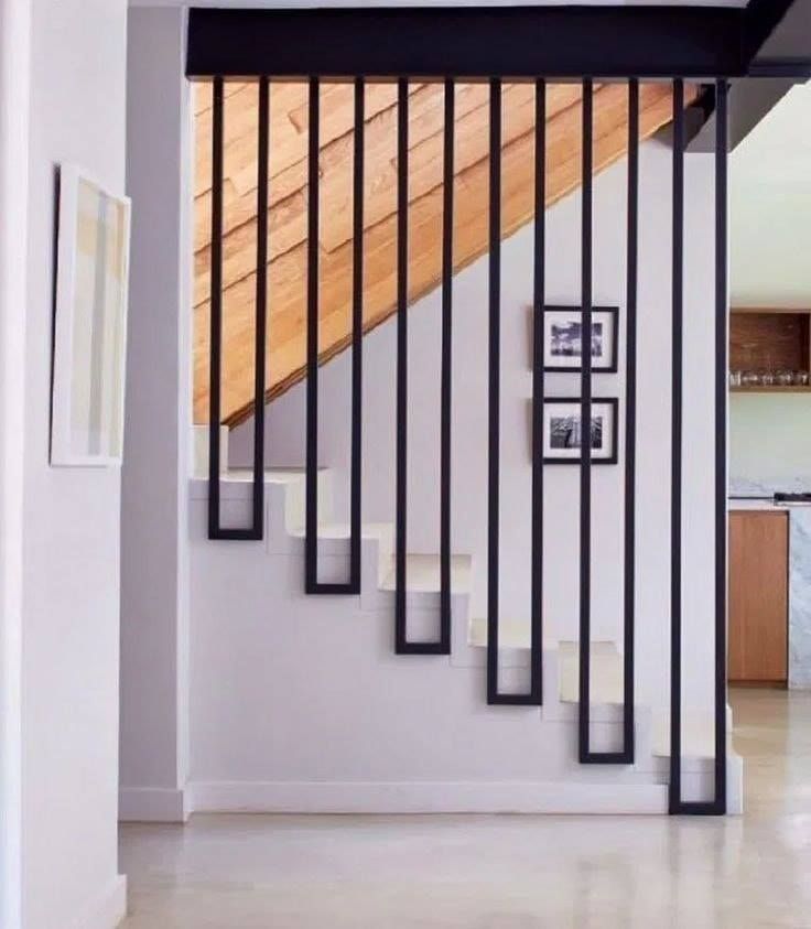 an open stair case with pictures on the wall