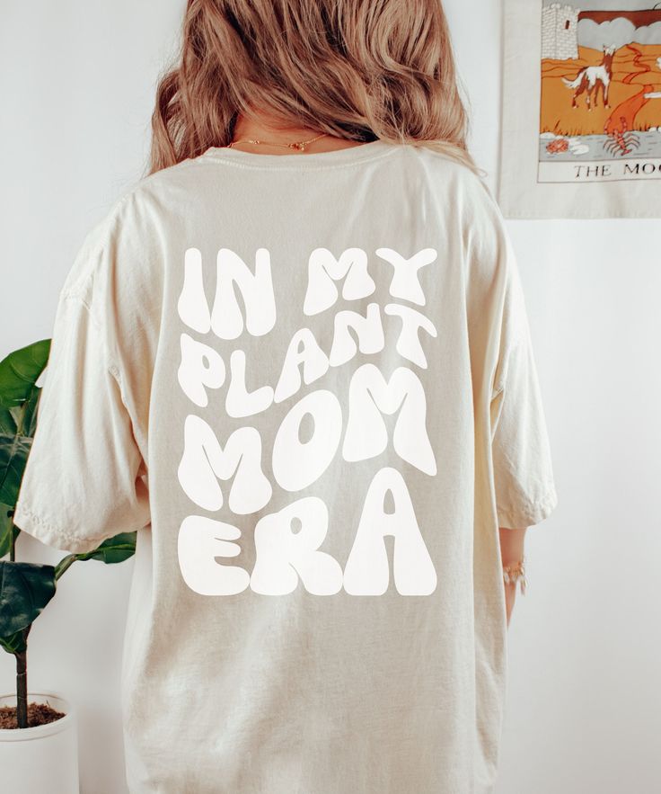 Garden T-Shirt, Mom Era Shirt, Funny Mom T-Shirt, Hot Mom Era Product Details: ✿ Dreamy, Soft Fabric ✿ 100% Ring-spun Cotton ✿ Expertly Designed & Printed Sizing Details: ✿ Relaxed Fit  ✿ Size Up for Oversized Fit Recommended Care Practices: ✿ Cold Water Only ✿ Turn Inside Out to Wash ✿ Wash With Like Colors ✿ Tumble on Low Heat to Remove Wrinkles After Air Drying ✿ Do Not Iron Design Shipping & Processing: ✿ Please allow 2-7 business days for production. ✿ Please allow 2-7 business days for US Shipping Thank you for choosing to support my small business. Please reach out if you have any issues! Relaxed Fit Graphic Print Top For Mother's Day, Mother's Day Short Sleeve Relaxed Fit Shirt, Relaxed Fit Short Sleeve Shirt For Mother's Day, Relaxed Fit Cotton Shirt For Mother's Day, Casual Organic Cotton Tops With Custom Print, Organic Cotton Top With Custom Print In Relaxed Fit, Relaxed Fit Organic Cotton Tops With Custom Print, Green Short Sleeve Tops For Mother's Day, Organic Cotton Tops With Custom Print And Short Sleeves