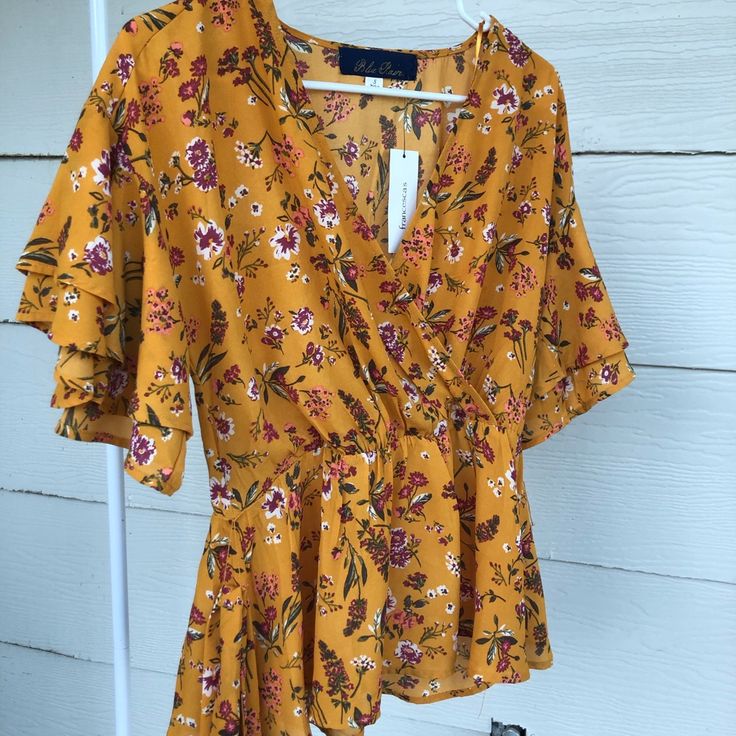 Good Quality, Flowy, Brand New , Never Worn, Has A Waist Belt , Low Cut Fits Like A Medium Chic Printed Yellow Tops, Chic Yellow Printed Top, Mustard V-neck Beach Top, Fitted Yellow Printed Blouse, Yellow Printed Blouse For Summer, Yellow Printed Blouse For Day Out, Mustard Floral Print Summer Top, Yellow Floral Print Top For Spring, Yellow Floral Print V-neck Blouse