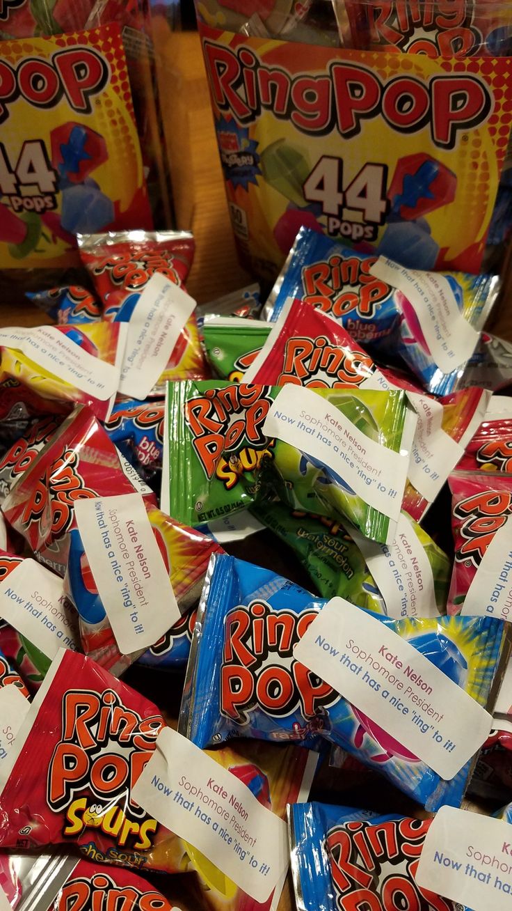 a pile of colorful candy bags sitting on top of each other