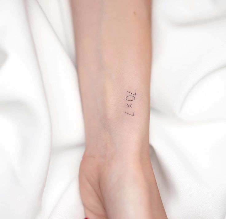 a woman's foot with the word love tattooed on her left ankle and wrist