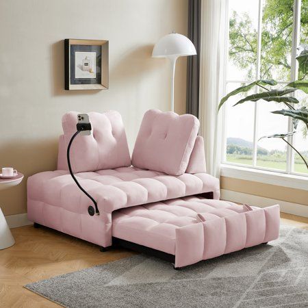 a living room with a futon couch and lamp on the floor next to a window