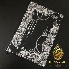 an intricate design on the back of a black book with gold lettering and arabic calligraphy