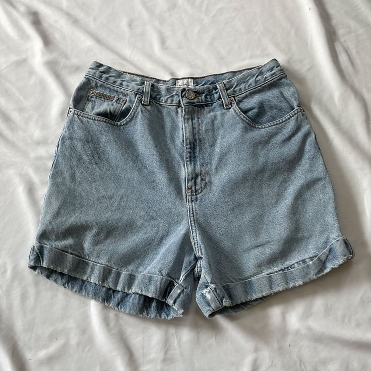 Vintage 1990s high waisted Calvin Klein shorts in medium wash denim. In good vintage condition. Note: I try to match colors as much as possible to pictures but there is a possibility it won't be an exact match. Unless the color is completely incorrect I am unable to offer refunds for this reason. Size: 12 Brand is Calvin Klein Measurements (taken on garment laid flat): Waist: 30" Hips: 43" Rise: 13" Inseam: 4.5" Fabric: 100% cotton Cheap Blue Levi's Shorts, Vintage High-waisted Jean Shorts For Spring, 90s Inspired Denim Shorts, Retro High Waist Medium Wash Shorts, 90s Inspired High Waist Medium Wash Bottoms, 90s Inspired High Rise Jean Shorts, Retro High-waist Medium Wash Shorts, High Rise 90s Inspired Summer Shorts, 90s Inspired High Rise Shorts For Summer