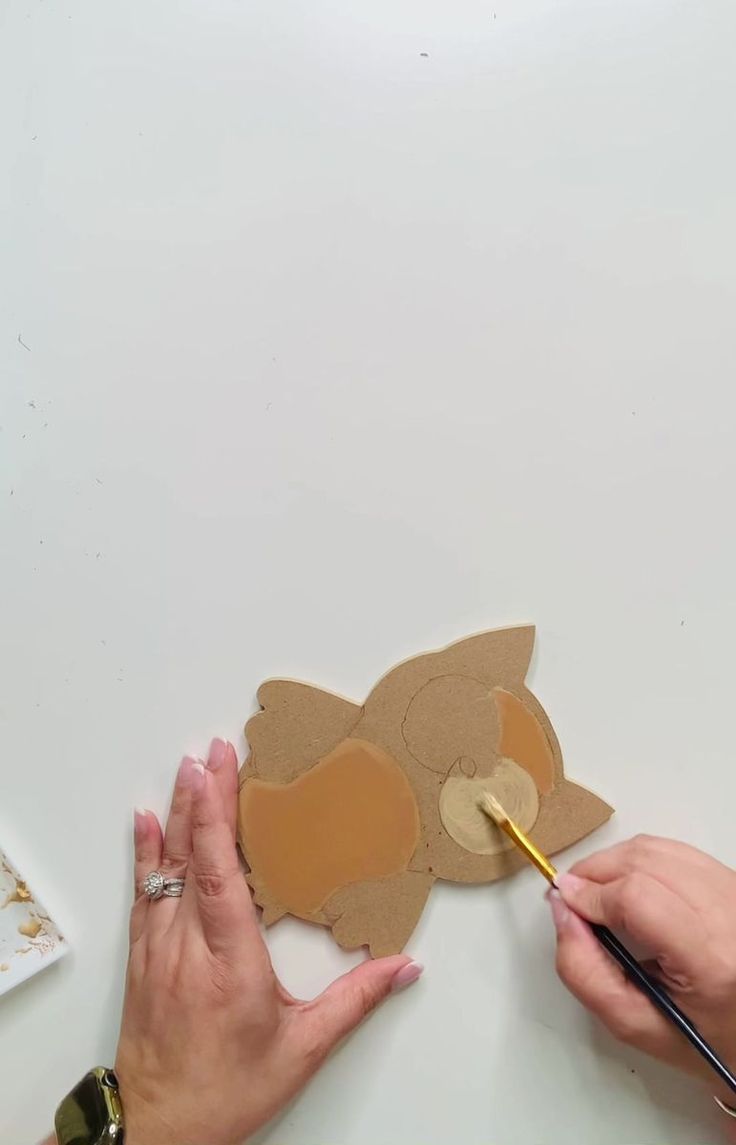 someone cutting out a cutout of a squirrel