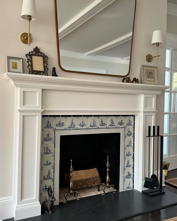 a fireplace with a mirror above it and other items on top of the mantel