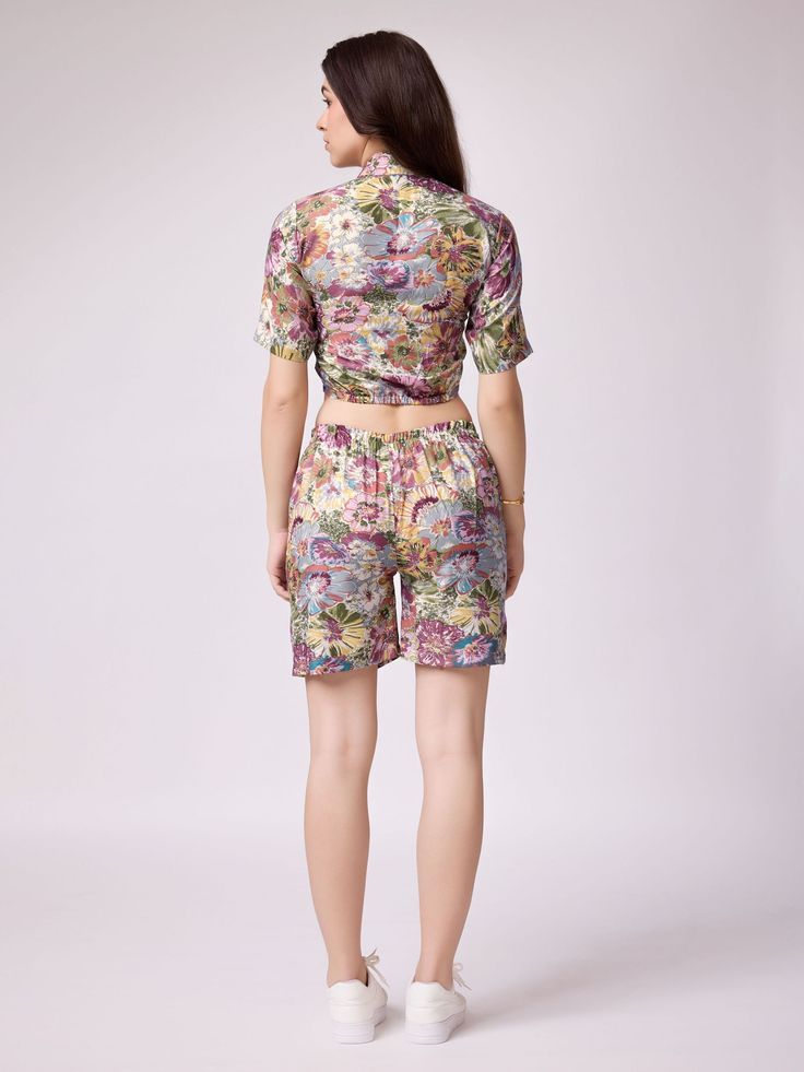 This co-ord set features a multi-color cotton material top with beautiful floral printed work, paired with matching cotton shorts also featuring the same floral print. Fully stitched and available in sizes S to XXL, this set is perfect for any body type.
This multi-color western top and shorts co-ord set are endless. Not only is it stylish and trendy, but it is also comfortable to wear for long hours. The floral print adds a touch of femininity and elegance to the outfit, making it perfect for f Cotton Short Sets For Spring, Spring Cotton Sets With Short Length, Cotton Short Length Sets For Spring, Multicolor Floral Print Loungewear Sets, Casual Multicolor Floral Print Sleepwear, Cotton Beach Sets With Short Length, Multicolor Floral Print Sleepwear For Spring, Cotton Beach Sets With Floral Embroidery, Cotton Beach Sets In Short Length