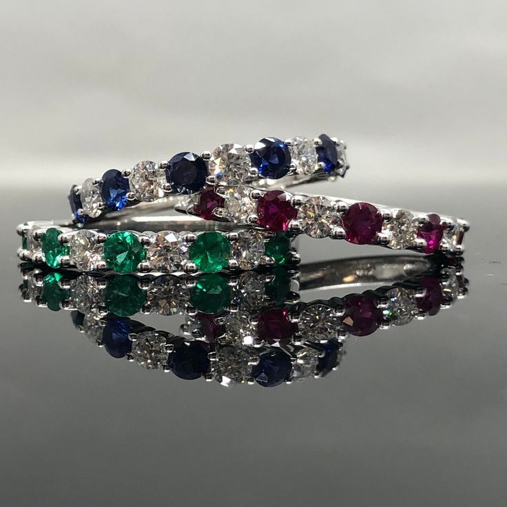 14K White Gold Sapphire and Diamond Band METAL: 14K White Gold TOTAL WEIGHT: 3.3 g DIAMONDS: Natural Round Brilliant Diamonds COLOR: G/H CLARITY: VS2-SI1 TOTAL WEIGHT: 0.40 ct GEMSTONES: Natural Round Brilliant Cut Emeralds FINE QUALITY TOTAL WEIGHT: 0.42 ct SIZE: Ladies 4-8. Please indicate your ring size at checkout. Contact us for all additional sizes. DESCRIPTION: This is a beautiful emerald and diamond band. It has 9 stones total,with diamonds and emeralds alternating. It's classic, prong s Anniversary Diamond Gemstones With Diamond Cut, Anniversary Diamond Cut Gemstones, Anniversary Diamond With Diamond Cut, Brilliant Cut Cubic Zirconia Gemstones For Anniversary, Classic Round Cut Diamond Gemstones, Anniversary Brilliant Cut Cubic Zirconia Gemstones, White Gold Round Multi-stone Gemstones, Diamond Cut Gemstones For Wedding, Classic Gemstone Eternity Band For Formal Occasions