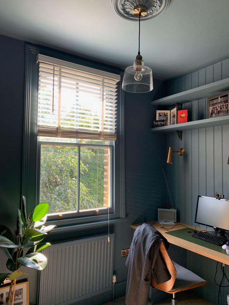 a room with a desk, chair and window