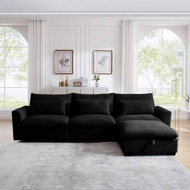 a living room with a large black couch